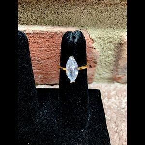 Costume gold ring with oval diamond like stone